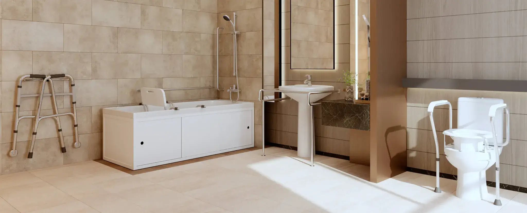 A sunlit, modern bathroom with cream-coloured tiles throughout. On the left, there is a walking assist device. Beside this is a bath and shower with a sliding seat and various bars for gripping. Centred is a sink with handlebars and space beneath for chair access. Above the sink is a mirror, well-lit from both sides. On the right, there is a toilet with side arms and vertically adjustable seat.